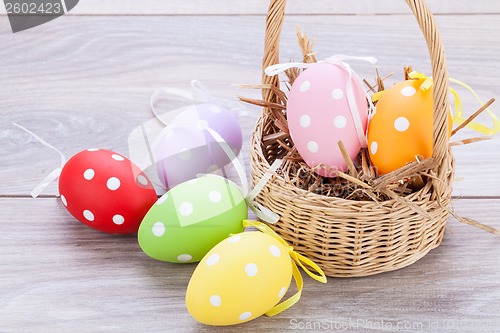 Image of colorful easter egg decoration on wooden background