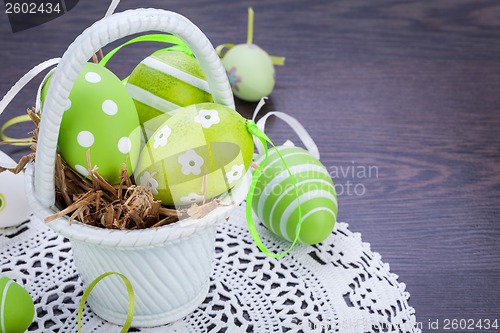 Image of Colourful green Easter eggs in straw