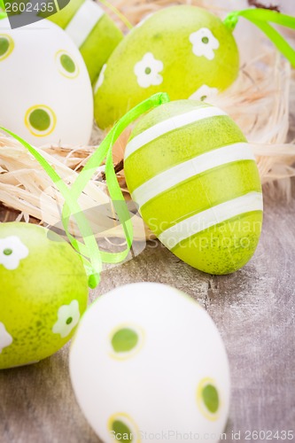 Image of Colourful green Easter eggs in straw