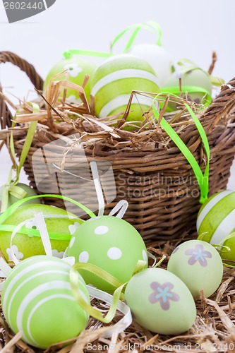 Image of Colourful green Easter eggs in straw