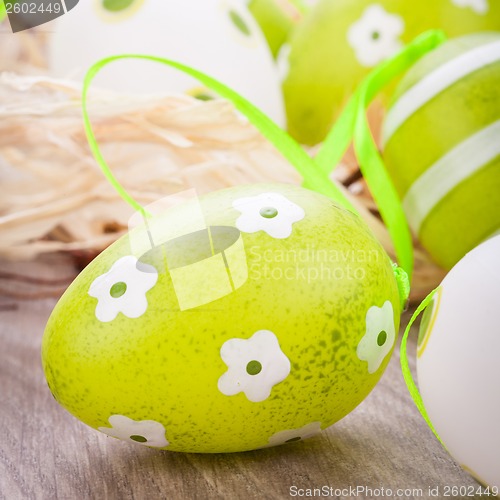 Image of Colourful green Easter eggs in straw