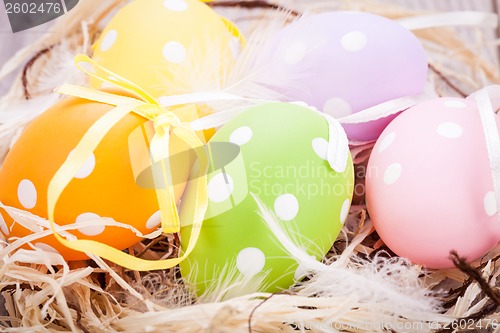 Image of colorful easter egg decoration on wooden background