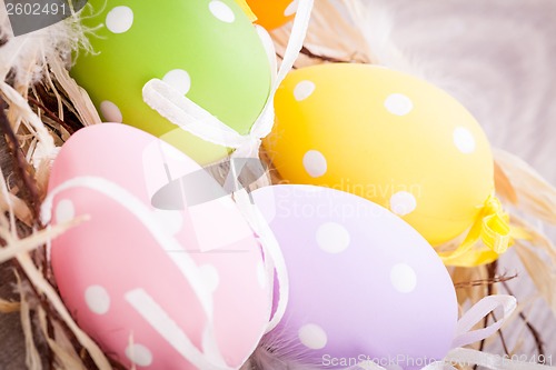 Image of colorful easter egg decoration on wooden background