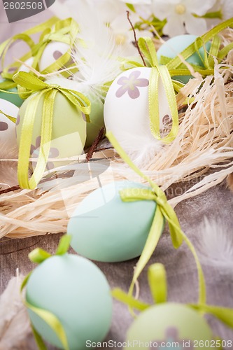 Image of Colourful green Easter eggs in straw