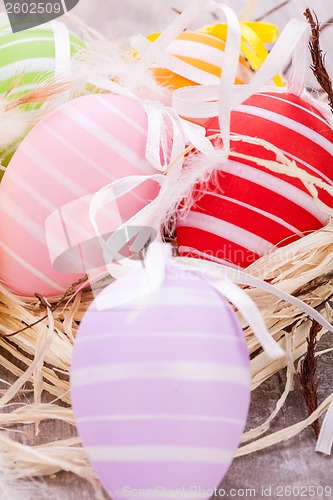 Image of colorful easter egg decoration on wooden background