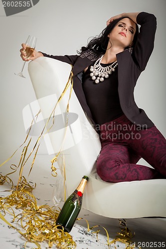 Image of Seductive brunette holding a glass of champagne