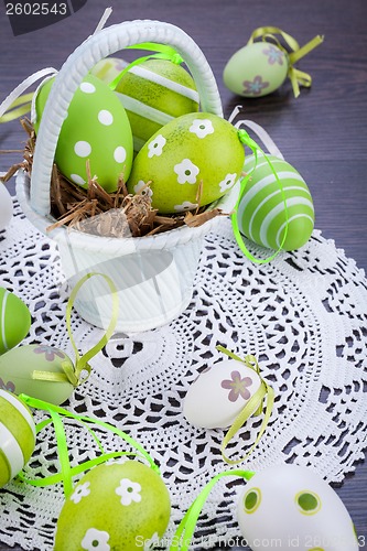 Image of Colourful green Easter eggs in straw