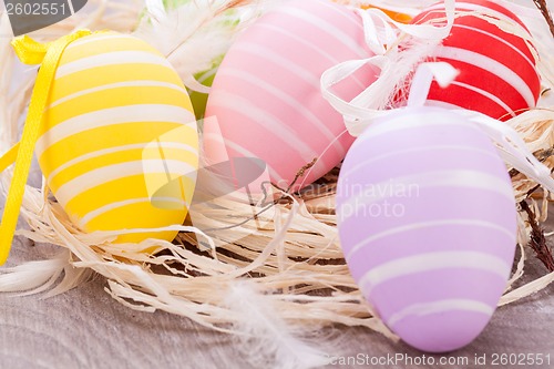Image of colorful easter egg decoration on wooden background