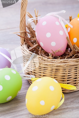 Image of colorful easter egg decoration on wooden background