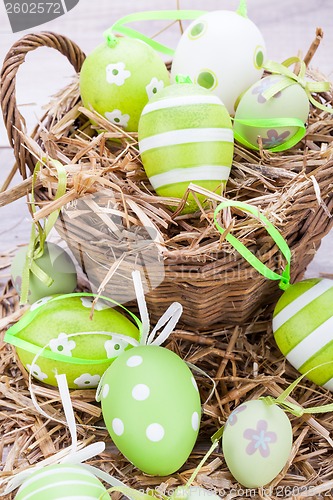 Image of Colourful green Easter eggs in straw