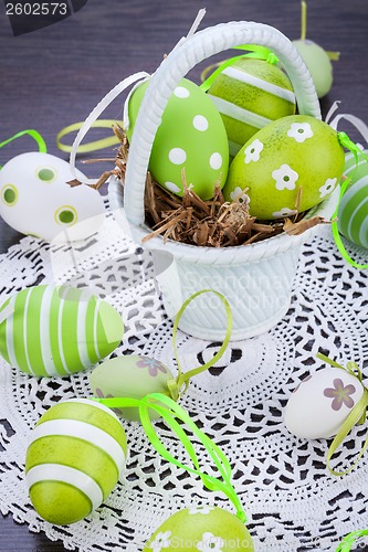 Image of Colourful green Easter eggs in straw