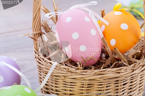 Image of colorful easter egg decoration on wooden background