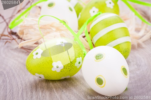 Image of Colourful green Easter eggs in straw