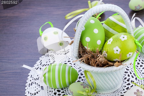 Image of Colourful green Easter eggs in straw