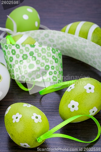 Image of Colourful green Easter eggs in straw