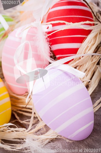 Image of colorful easter egg decoration on wooden background