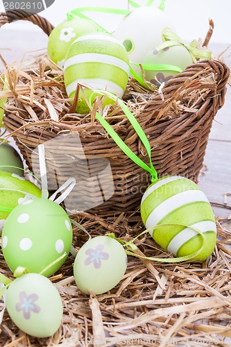 Image of Colourful green Easter eggs in straw