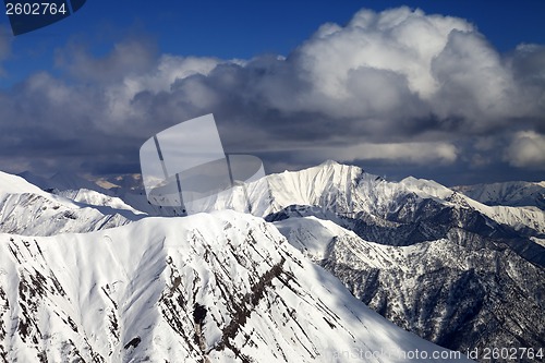 Image of Snowy ridges with trace from avalanche