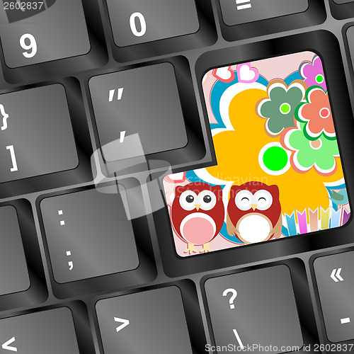 Image of owl on computer keyboard key with flowers