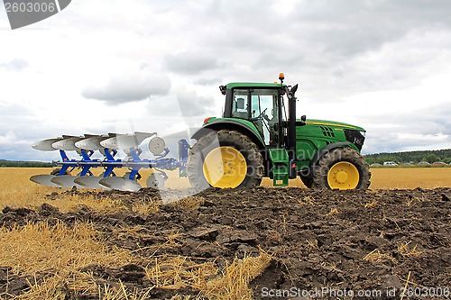 Image of John Deere 6150M Tractor with a Plow on a Field