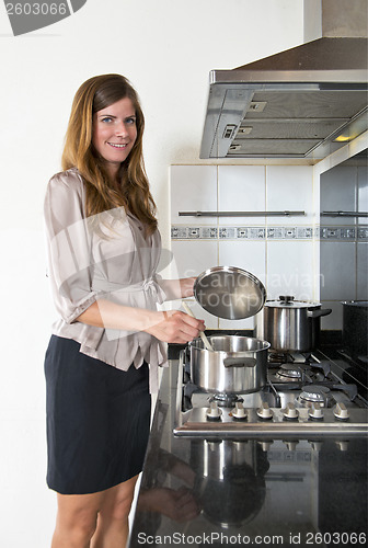 Image of Business woman cooking