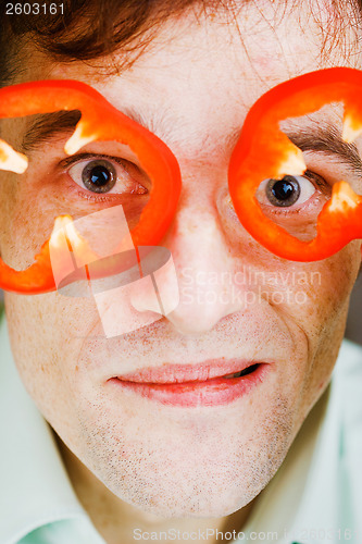 Image of Young man with red pepper. humor