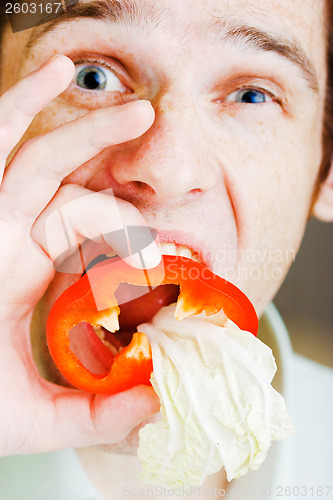 Image of Young man with red pepper. humor