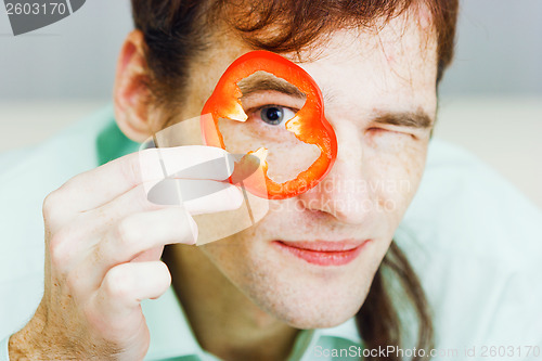 Image of Young man with red pepper. humor