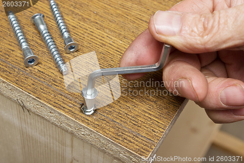 Image of Tightening the screws by hand when assembling furniture