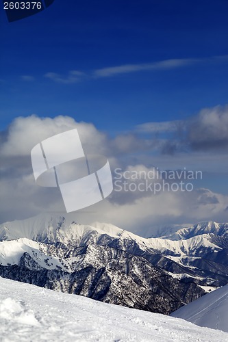 Image of View on cloudy mountains and off-piste slope