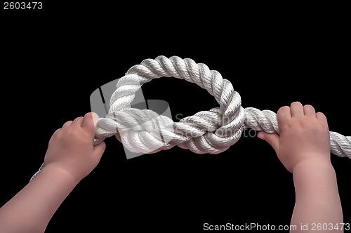 Image of Baby hands holding overhand knot