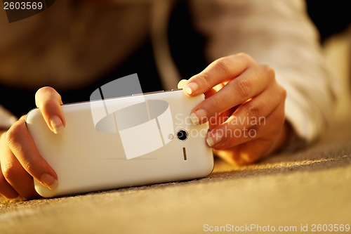 Image of Woman taking photos with her phone