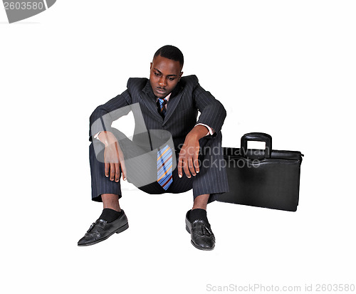 Image of Man sitting on floor..