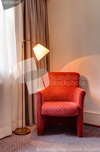 Image of Red armchair and lamp in the room corner