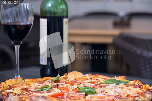 Image of Piiza and vine on the table