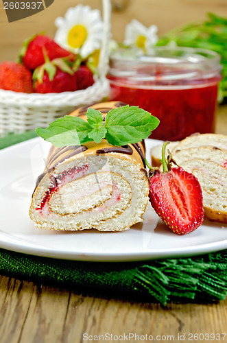 Image of Roulade with a jar of jam and strawberries on a board