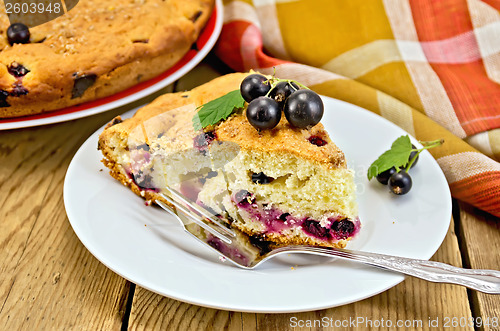 Image of Pie with black currant on the board with a fork