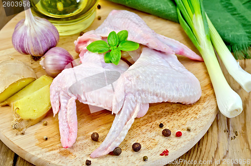 Image of Chicken wings with garlic on a board