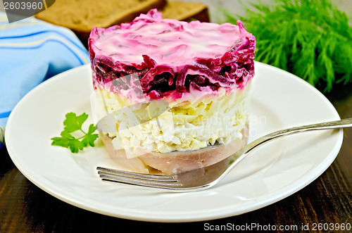 Image of Herring with vegetables and egg in a plate with a fork