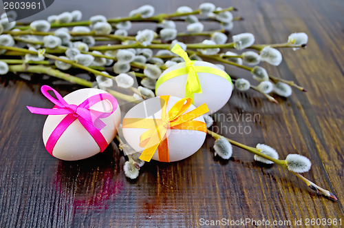 Image of Easter eggs with ribbons and willow on the board