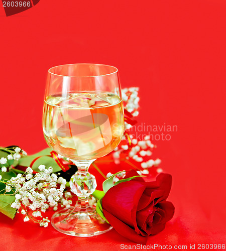 Image of Wine in a glass with a rose