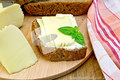 Image of Sandwich with cheese suluguni and butter on board