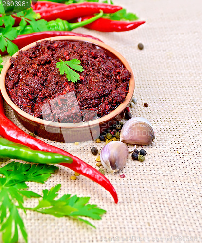 Image of Adjika with hot pepper and garlic on burlap