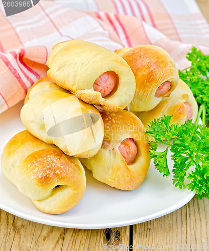 Image of Sausage rolls with parsley on the board