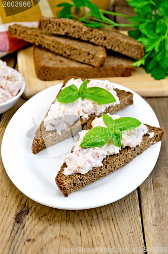 Image of Sandwiches with cream of salmon with bread on the board