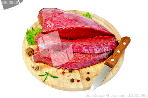 Image of Meat beef with parsley on a round board