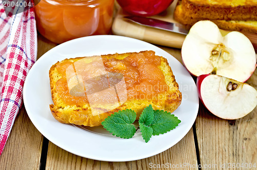 Image of Bread with apple jam and apple on a board