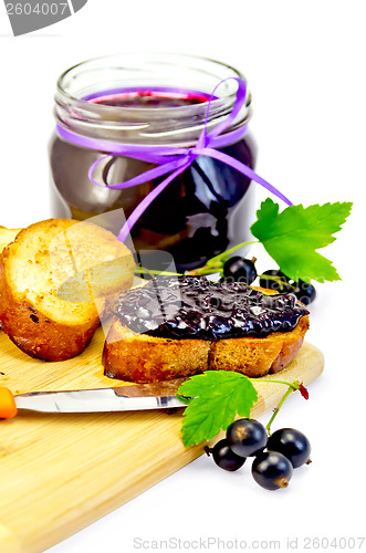 Image of Bread with jam from blackcurrant on a board