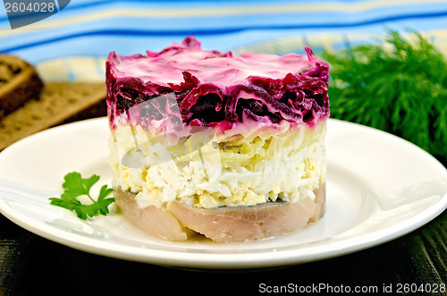 Image of Herring with vegetables in white plate on a board