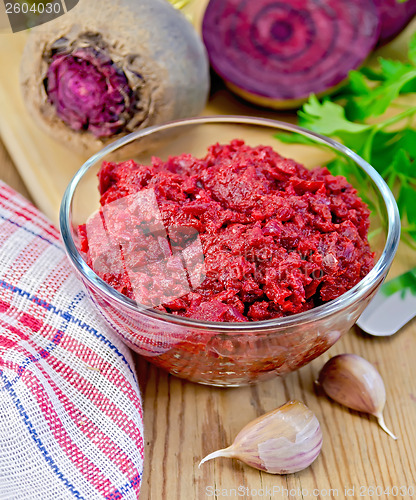 Image of Beet caviar in a glass bowl on a blackboard